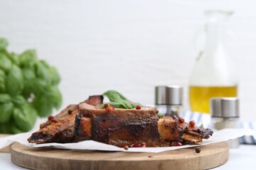 Roasted beef ribs with spices on white table, closeup