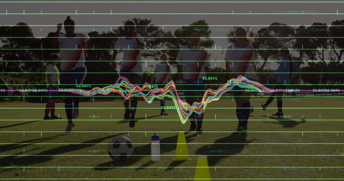 Lining up players wearing matching jerseys warming up on pitch with ball bottle cones grid waveform - Powered by Adobe