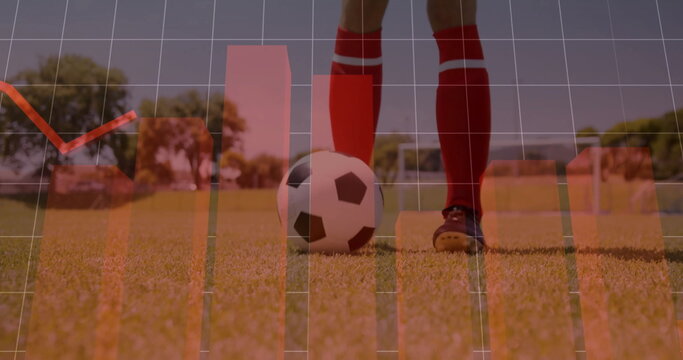 Standing athlete wearing red socks, black cleats on soccer field, with ball goalposts, data overlay