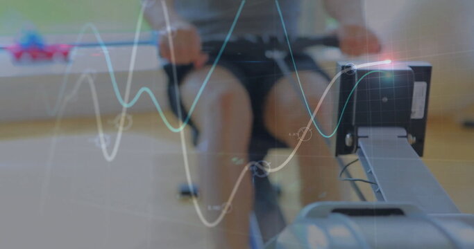 Rowing fit man pulling handlebar on rowing machine at fitness room, with digital display overlays