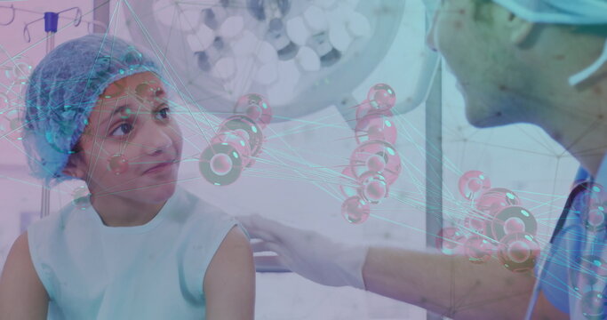 Doctor in scrubs placing hand on schoolgirl in gown in exam room, with molecular network overlay - Powered by Adobe