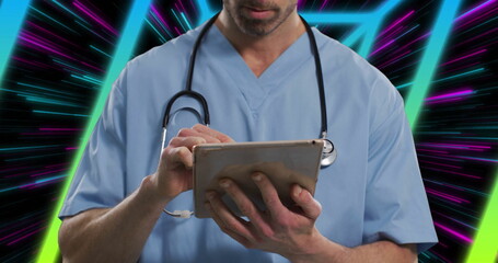 Tapping tablet, professional wearing blue scrubs, stethoscope navigating screen in neon background