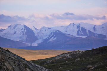 mountain landscape with snow-capped peaks at sunset