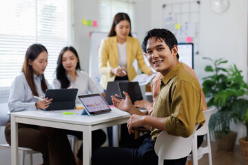 Group of Asian business people teams meeting working together in modern office working design planning and ideas concept
