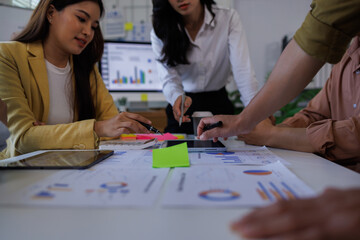Fototapeta premium Asian Business financial Team, accountant discussing with partner are meeting to audit finance planning sales to meet targets set in next year. stock market concept.. 