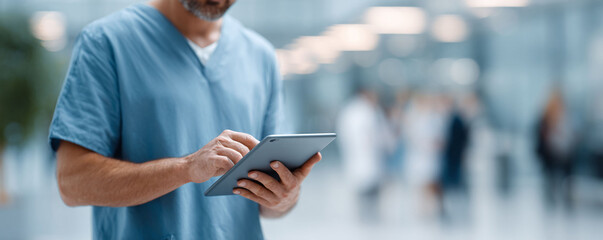 Modern healthcare worker using a digital tablet in a bright, busy hospital environment. Depicts technology, efficiency, and communication in medicine.