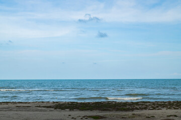 Sunny beach with blue sea and sky