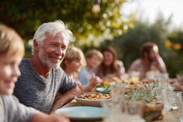 Heartwarming shot of a family gathering outdoors, sharing a meal. Emphasizes togetherness, joy, and intergenerational connections. Perfect for lifestyle, food, and familyrelated projects.