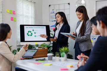 Fototapeta premium Team of asian business ESG environmental social governance policy for modish business to set a standard to achieve high ESG score 