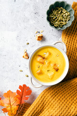 Warm and inviting autumn soup served in a rustic bowl, garnished with croutons and pumpkin seeds.