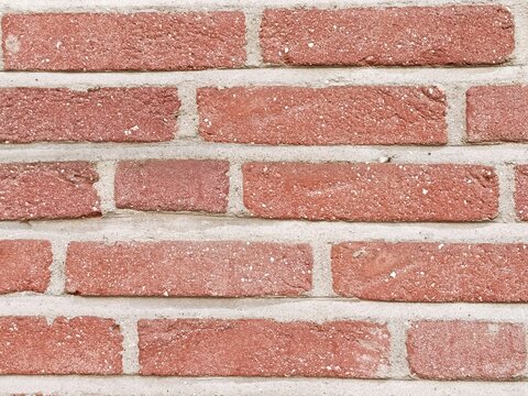 Red brick wall with contrasting light gray mortar architectural background