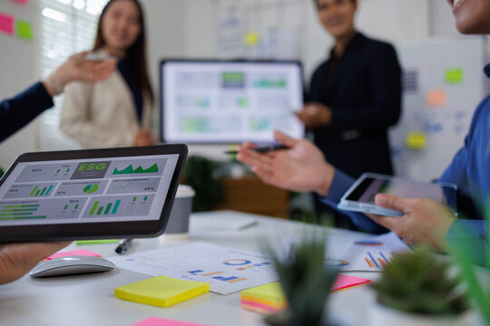 diversity asian team discussion focused and talk ESG strategies risk,environment,social,governance for net zero goals in a sustainable green office - Powered by Adobe