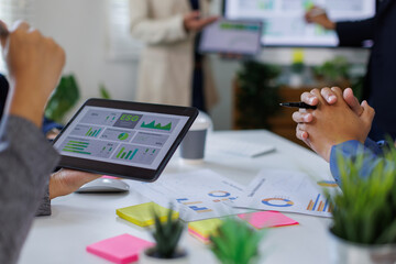 Asian team lead young group of multiethnic businesspeople in team meeting, using computer for ESG topic presentation on monitor. Sustainable business practice, people work esg concept
