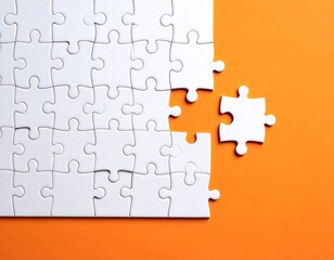 Fototapeta premium White jigsaw puzzle with missing piece on orange background