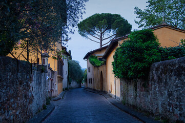 Empty narrow street of the old district of Florence the evening