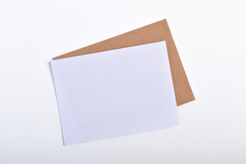 Kraft paper envelope and blank letter isolated on white background