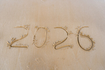 2026 numbers written in the sandy beach background.