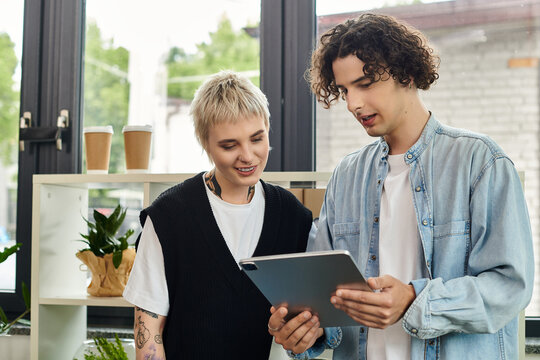 Youth engaged in collaborative work with digital device in a modern office setting