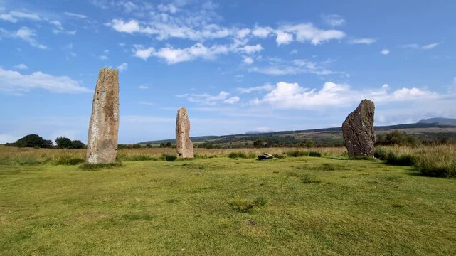 Ancient Machrie Moor standing stones on the Isle of Arran, Scotland, with dramatic moorland landscape and cloudy sky