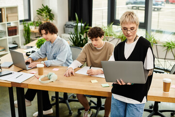 Dynamic youth collaborating in a vibrant office environment while focusing on work tasks