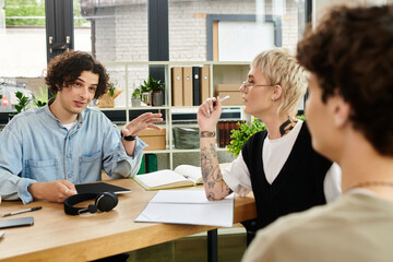 Young professionals engaged in a spirited discussion in a vibrant office environment