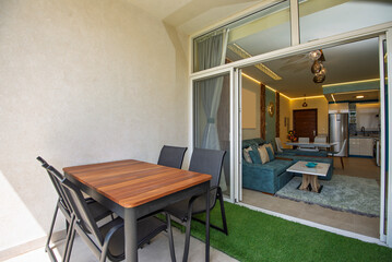 Garden patio terrace of a luxury apartment home in tropical resort with furniture and garden