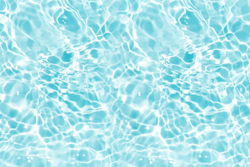 Blue water with ripples on the surface. Defocus blurred transparent blue colored clear calm water surface texture with splashes and bubbles. Water waves with shining pattern texture background.