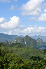 Lush Green Mountains Under Blue Sky and White Clouds in Scenic Natural Landscape