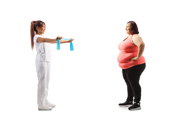 Physical therapist showing exercise to a corpuplent woman