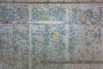 Weathered public bulletin board with remnants of past posters, peeling tape, and community event flyers creating textured urban collage