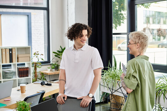 Engaging conversation in a modern office setting between two young professionals