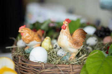 The eggs are in the basket. A toy chicken with eggs. The baby bird is sitting in the curtain.