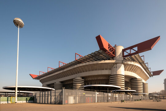 San Siro Stadium in Milan, Italy, under bright sunlight. Exterior architecture view of the iconic football arena, famous home of AC Milan and Inter Milan. Future venue for 2026 Winter Olympic