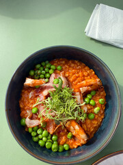 Oatmeal with shrimps, peas and bacon. Top view breakfast concept