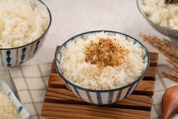 A bowl of white rice topped with rice seasonings.