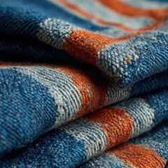 Fototapeta premium Textured fabric with artistic patterns in vibrant blue and orange hues showcasing intricate woven design elements and craftsmanship