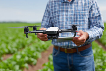 Close up, A farmer controlling drone spraying crops , no logo, no text