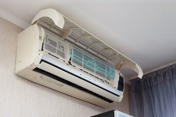 Air conditioner on the wall open cover for service in an apartment or house.
