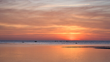 Sunset over the sea, golden light reflections and silent expanse