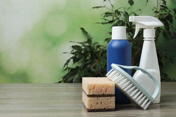cleaning product, sponge, gloves on a background of green trees

