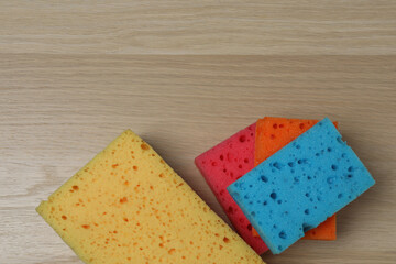 cleaning product, sponge, gloves on a wooden background
