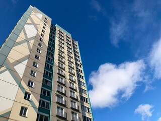 facade of an apartment building against a blue sky