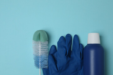 cleaning product, sponge, gloves on a blue background

