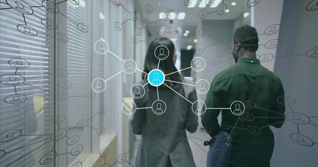 Two colleagues walking office corridor holding cups activating network overlay showing data links - Powered by Adobe