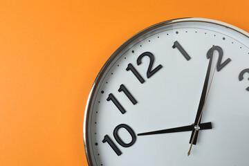 wall clock on orange background
