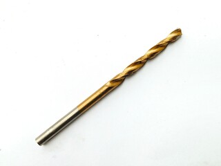 A close-up of a brass-coated metal drill bit on a white background.