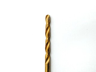A close-up of a brass-coated metal drill bit on a white background.