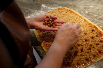 Detail of the preparation of Gubana, a typical Friulian cake, with the addition of sultanas to the...