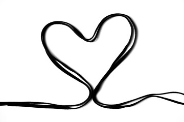 Black shoelace in a shape of heart isolated on white background
