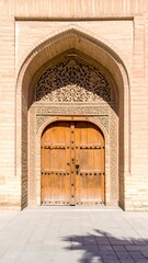 Ornate arched entryway with aged wooden doors
